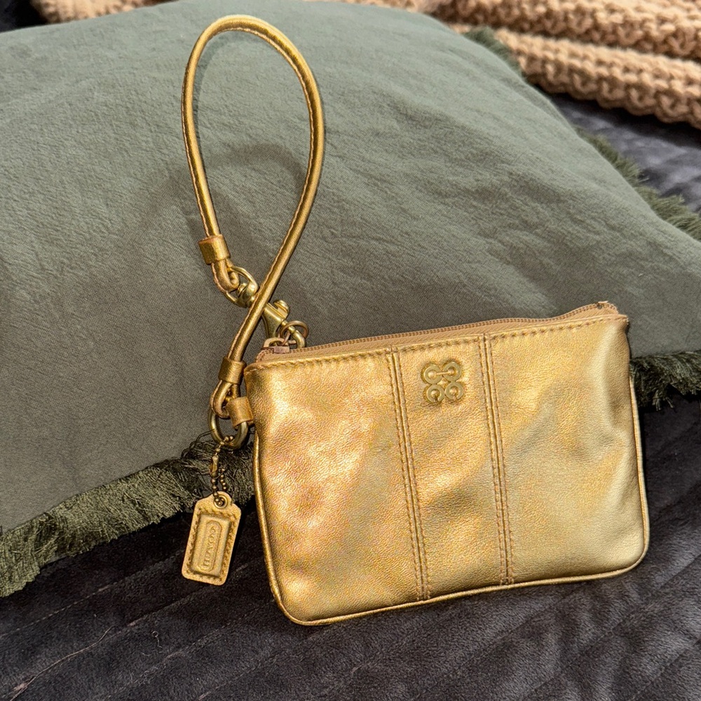 Coach Gold Wristlet - with hang tag. EUC - pink interior.